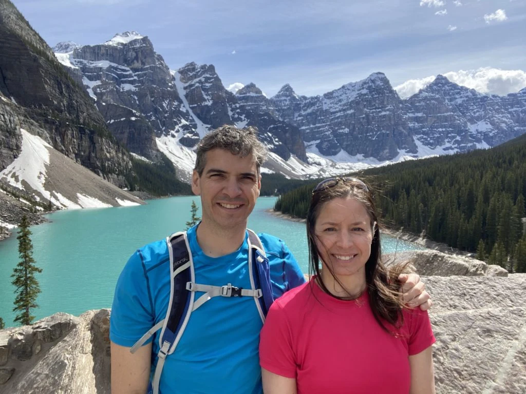 Robert Pomerleau and Martine Gagnon hiking beside a turquoise lake in the Canadian Rockies