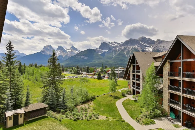 Canmore resort buildings surrounded by trees and mountain views